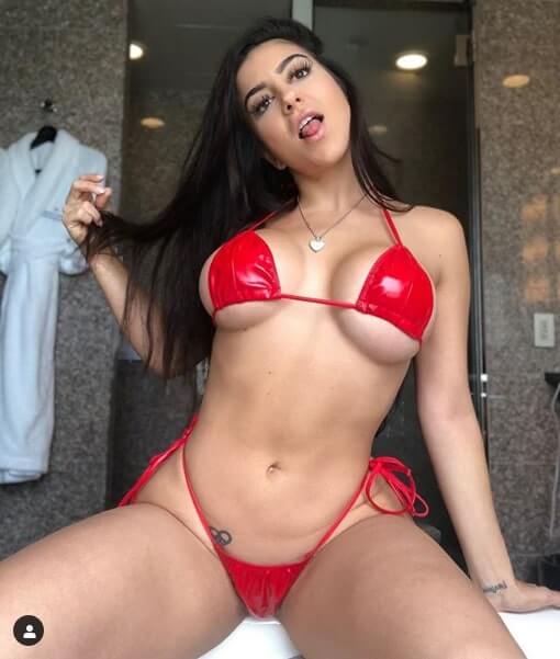 lenatheplug, hot Instagram model, wears red skimpy bikini that barely covers her massive tits.